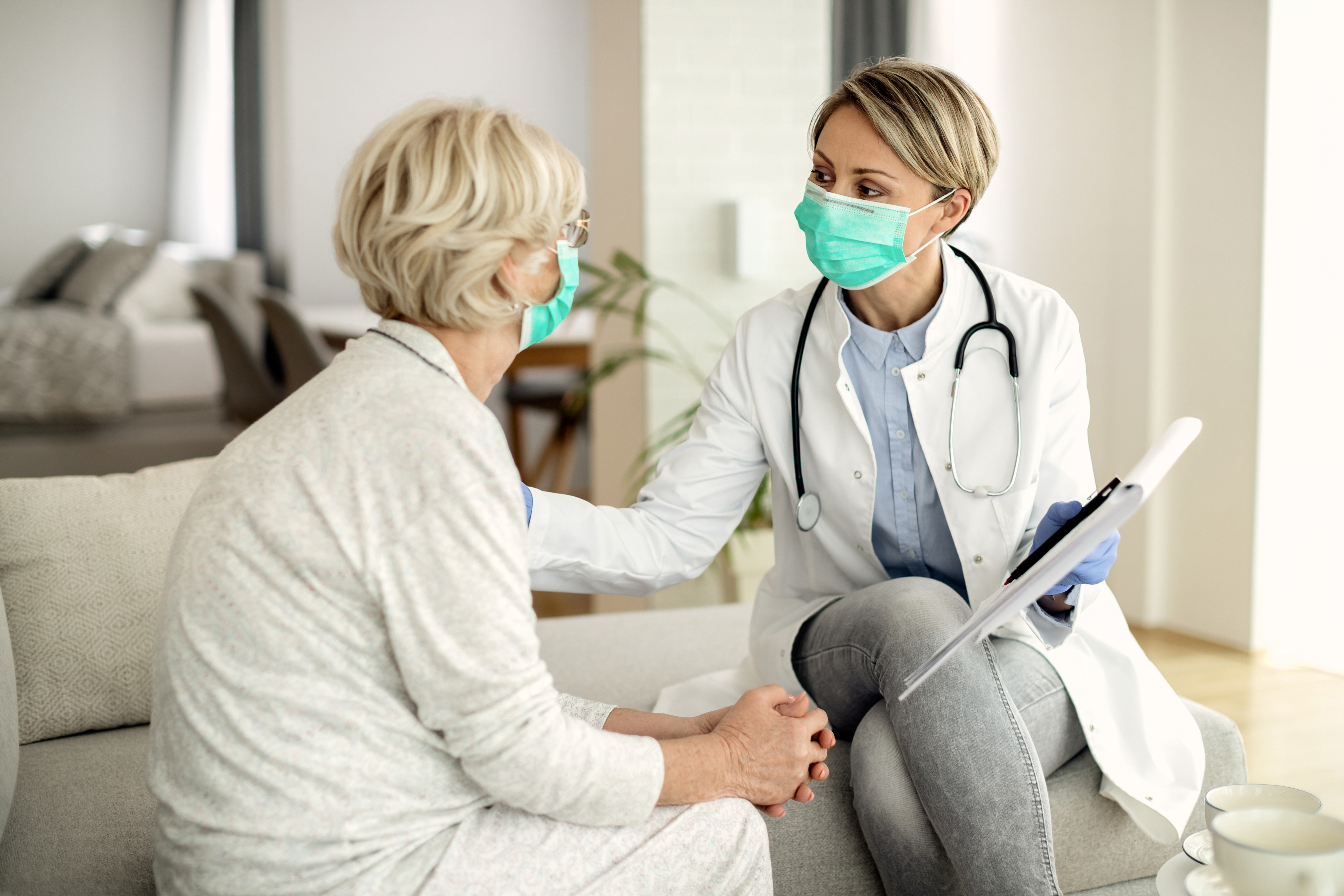 OnCure doctor assisting a mobility patient at home doorstep in Dubai